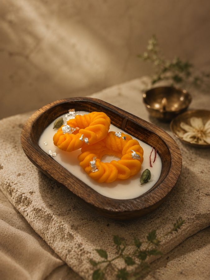Imarti — kesar-orange twisted mithai candles with silver vark
